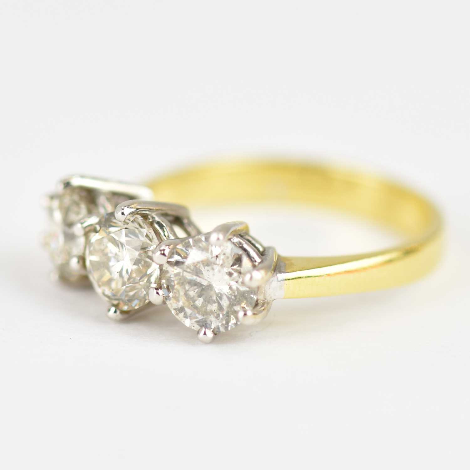 An 18ct yellow ring set with three claw set brilliant cut diamonds, each approx. 0.6ct, total 1.8ct, - Image 2 of 4