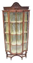 A mahogany William and Mary style glazed display cabinet, with concave and convex glazed panels,