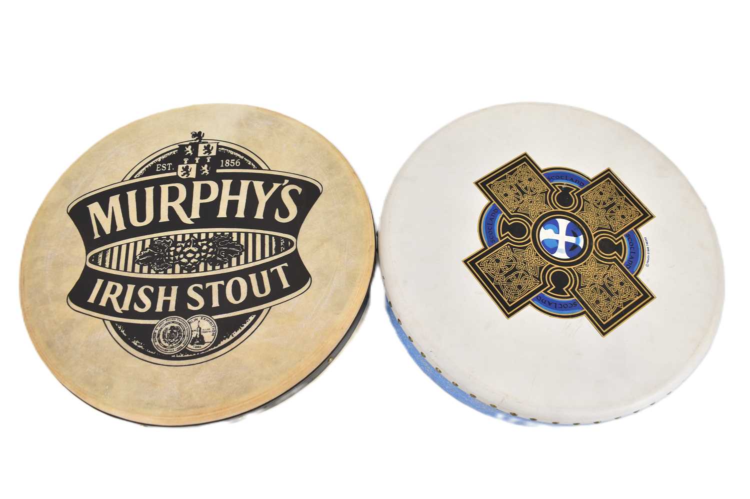 Two bodharan drums comprising 'Murphy's Irish Stout' and 'Hewlin' with Celtic design, both with