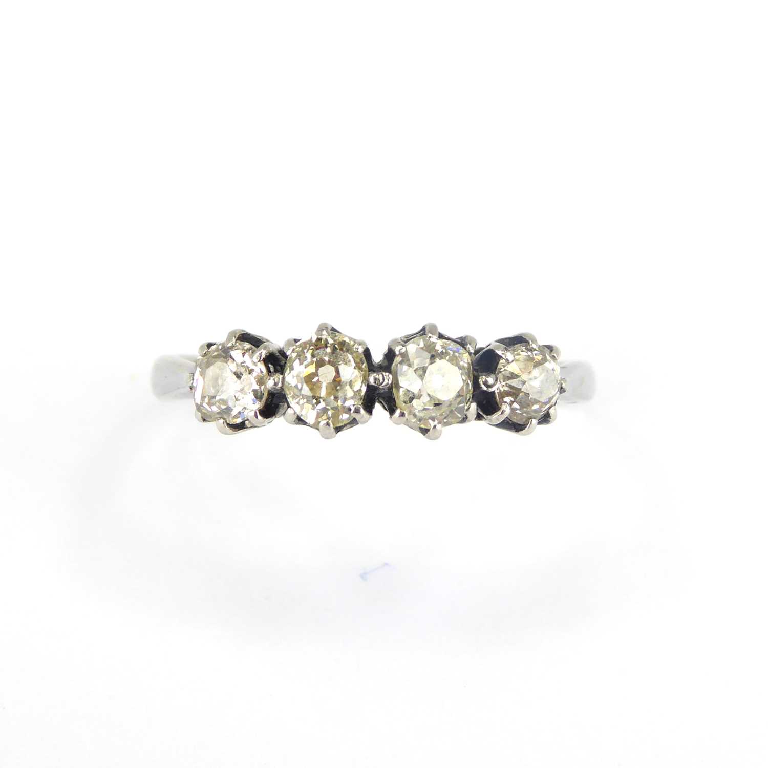 An 18ct white gold ring, the head set with four claw set rose cut diamonds with a slight tinge of