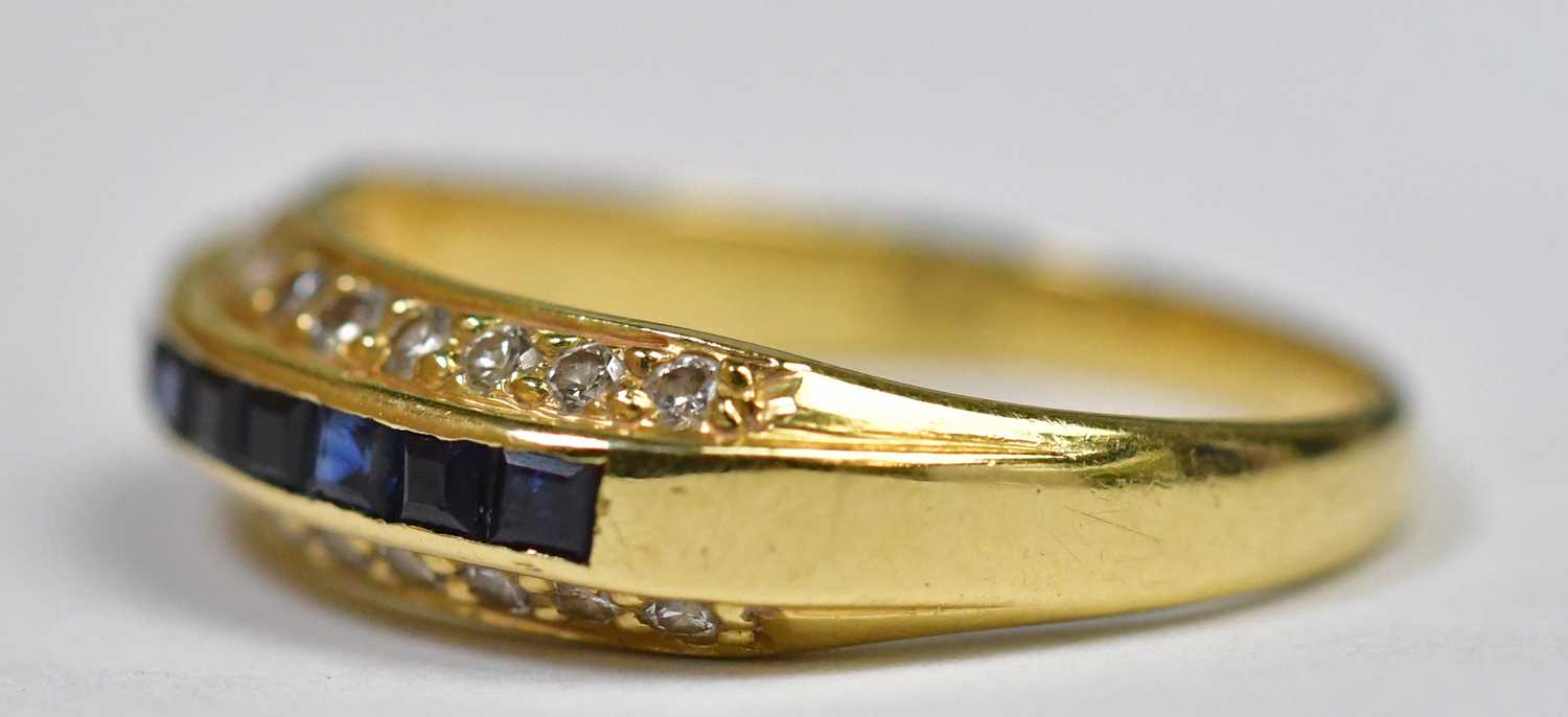 An 18ct gold diamond and sapphire ring, the four central channel set square cut sapphires flanked by - Image 6 of 9