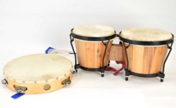 A pair of Bongoset bongos, 18 x 20cm, and a tambourine, diameter 25cm.