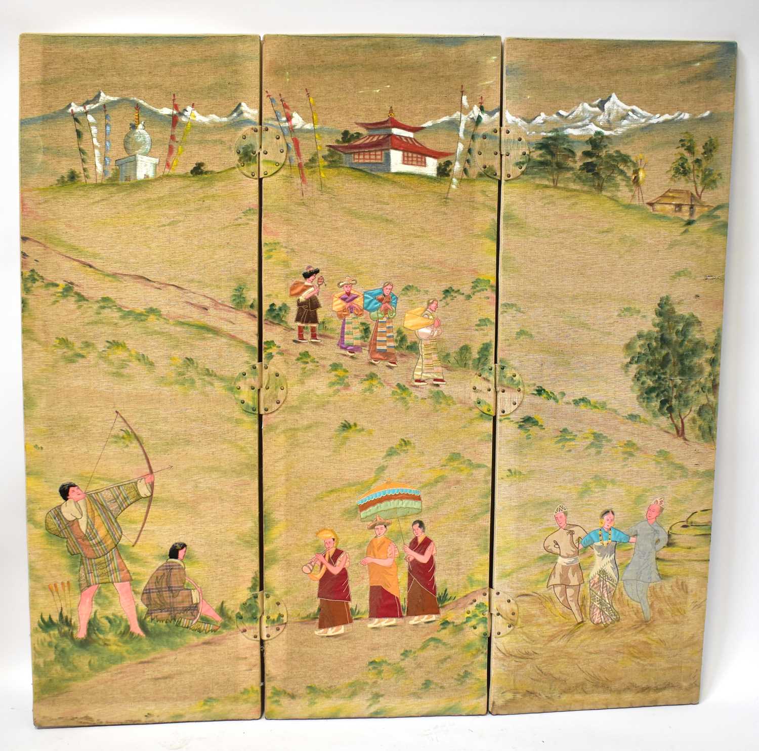 An Oriental-style three-section screen, with hand painted buildings in a landscape to the background
