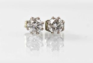 A pair of white metal diamond stud earrings, each claw set diamond approx. 0.5ct (unmarked).