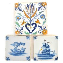 Three 18th century tin glazed tiles comprising a large polychrome decorated tulip and floral pattern