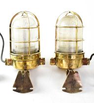 A pair of ship's brass walkway lamps converted to electricity, with clear ribbed shades, height 22cm