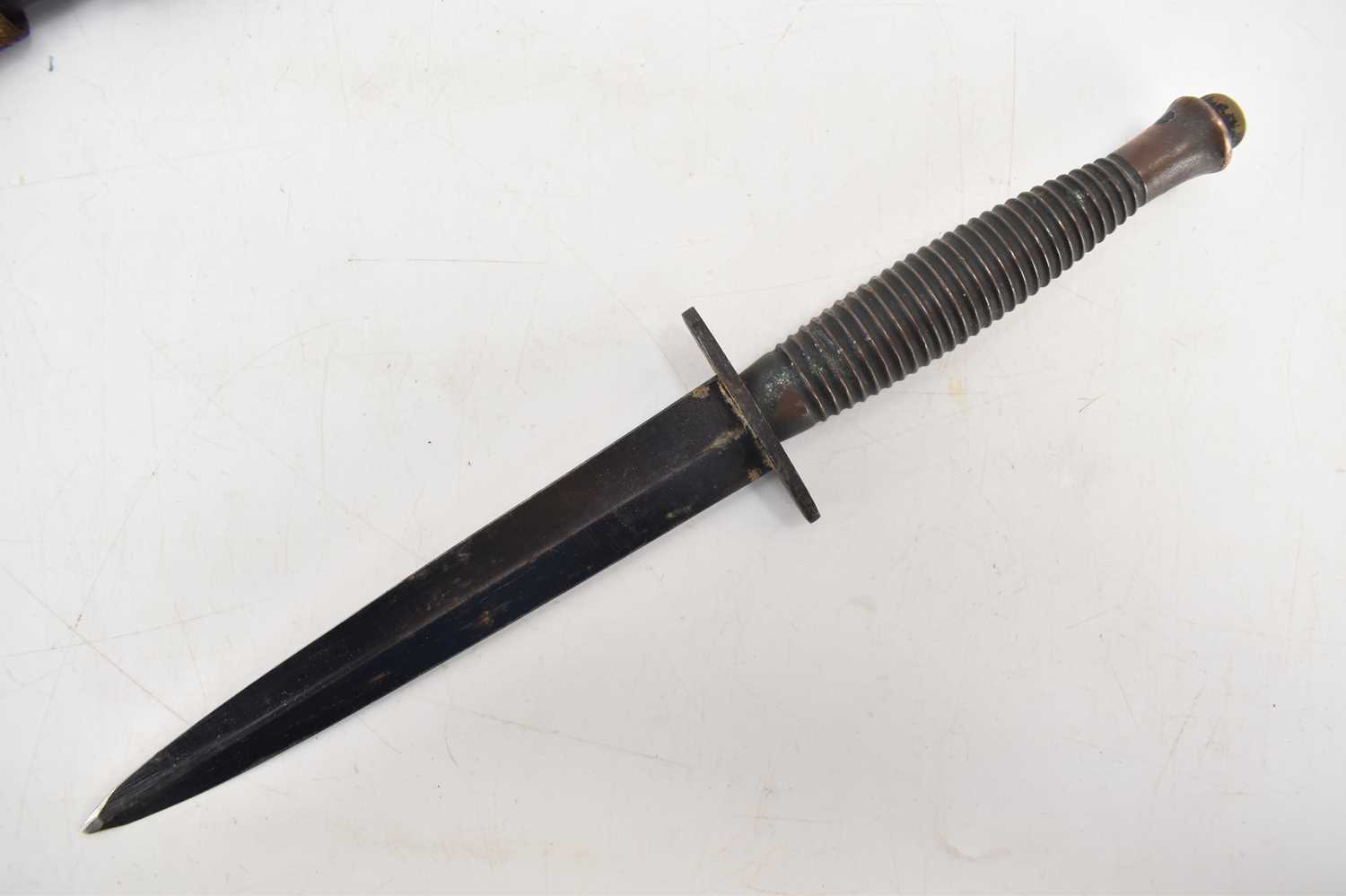 A WWII third pattern Fairbairn Sykes fighting knife, unmarked, with brass ribbed handle, double- - Image 2 of 2
