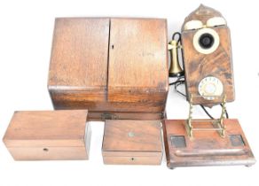 A reproduction wall mounted telephone converted to modern phone line, with brass fittings, an oak