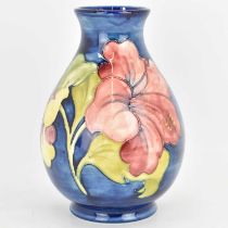 WALTER MOORCROFT; a blue ground 'Hibiscus' pattern bulbous-shaped vase, with paper label to base,