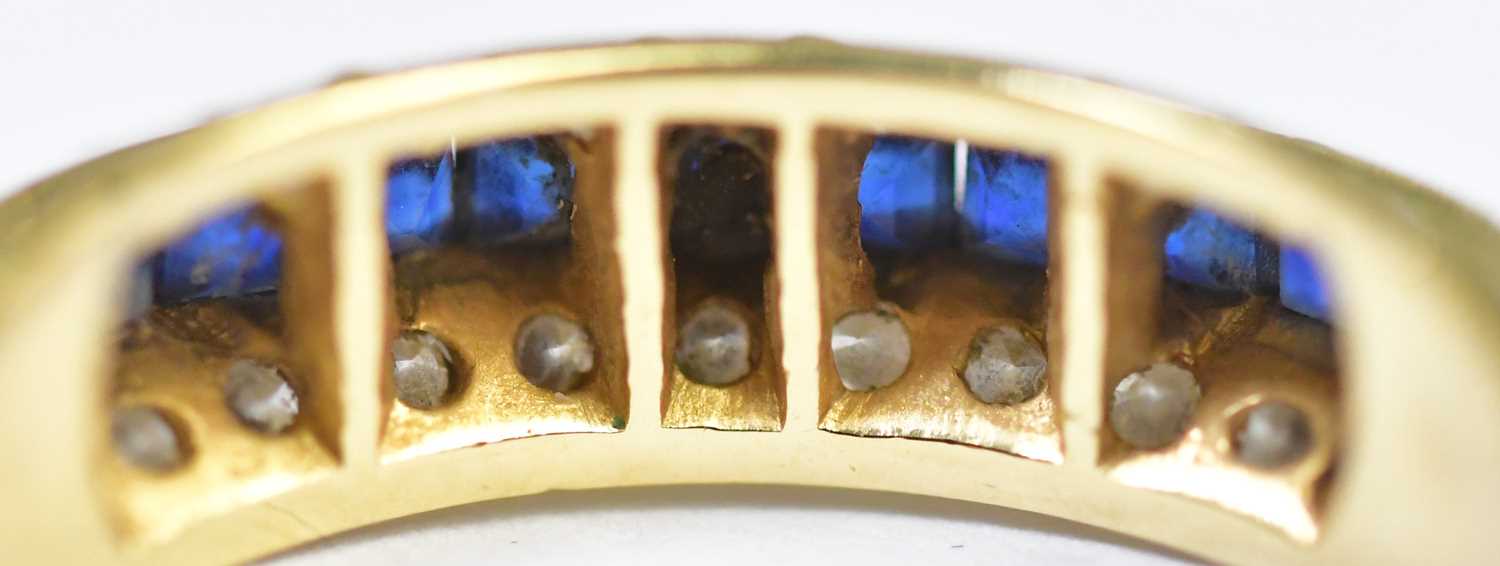 An 18ct gold diamond and sapphire ring, the four central channel set square cut sapphires flanked by - Image 7 of 9