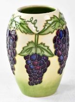 MOORCROFT; a vase decorated with bunches of grapes, copyrighted for 1996, with impressed and painted