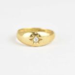 An 18ct gold ring with star inset tiny brilliant cut diamond, size P, approx. 4.7g.