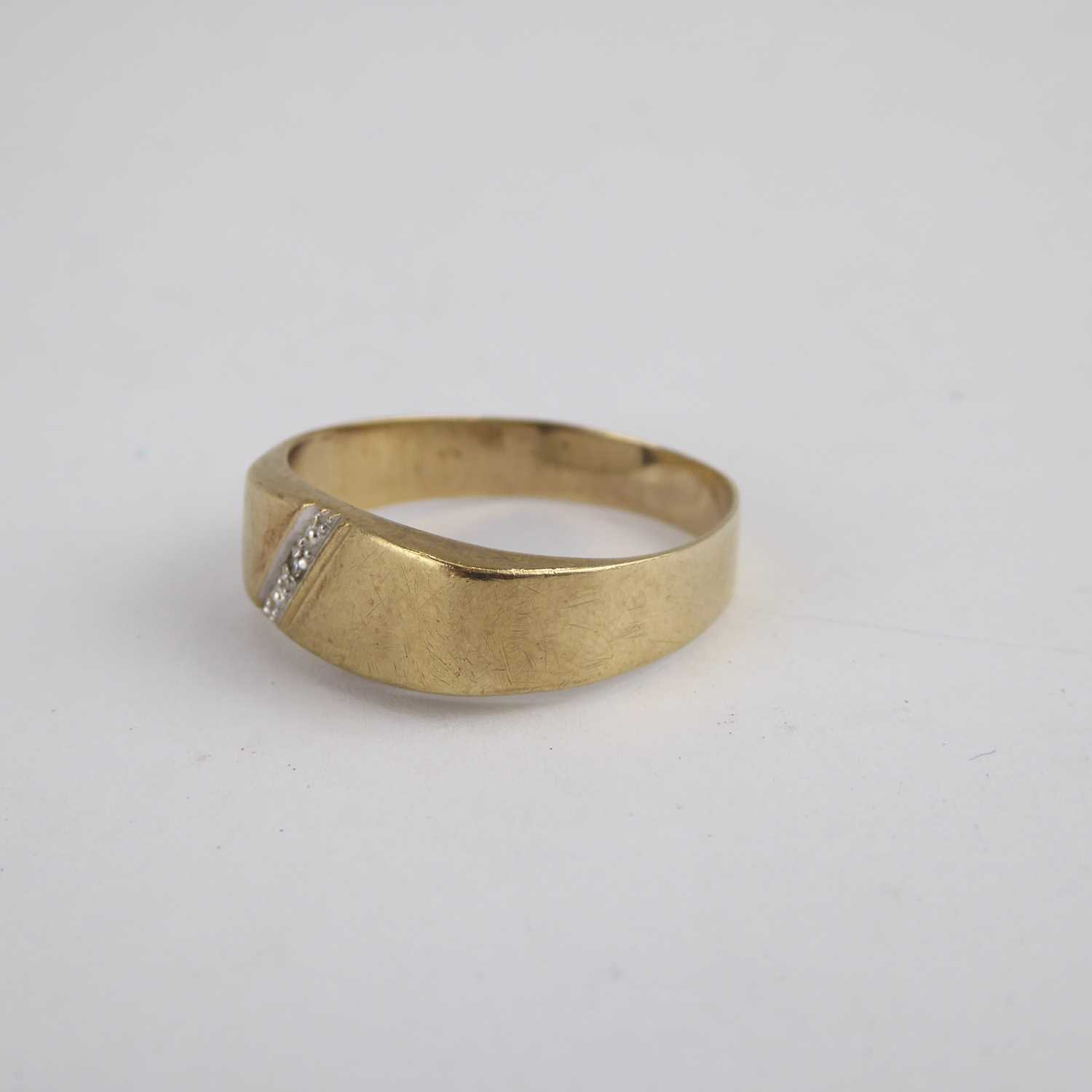 A 9ct gold band ring with flat table and diagonal diamond set line, size X, approx. 2.2g. - Image 3 of 4