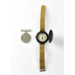 A military wrist compass on a webbing strap and a WWII War Medal (2). Condition Report: - The