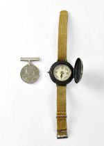 A military wrist compass on a webbing strap and a WWII War Medal (2). Condition Report: - The