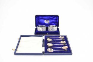 A cased set of six silver teaspoons with coffee bean finials, together with a pair of white metal