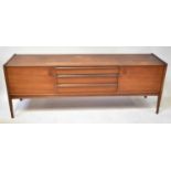 YOUNGER; a 1960s teak sideboard, with three long central drawers flanked by cupboards, raised on