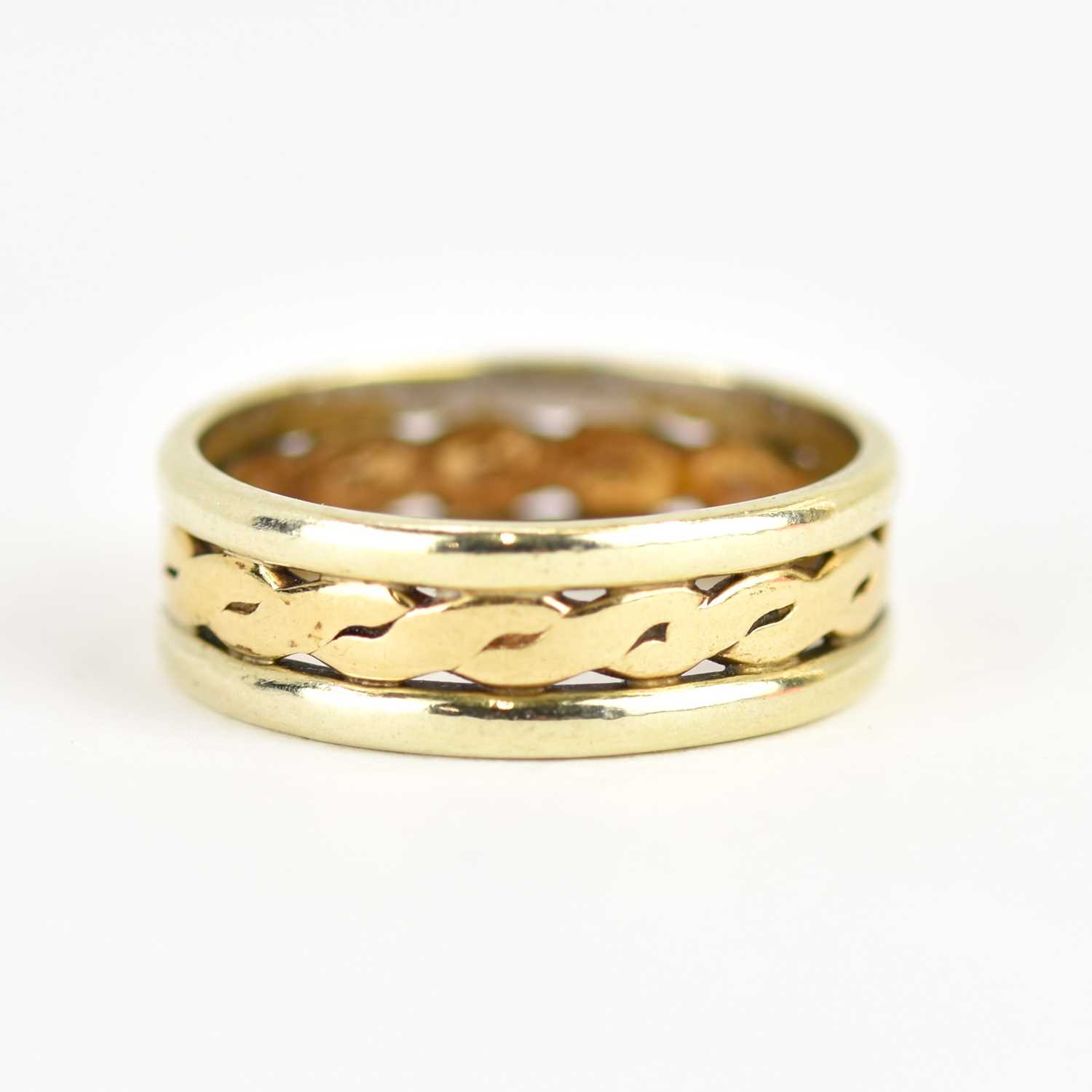 A 9ct gold two-colour band ring, the open central band with Celtic pattern flanked by white gold,