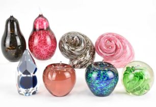 Eight glass paperweights to include pear, apple, snail shells, faceted sphere, and one with two fish