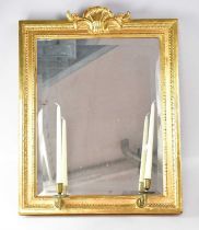 A Georgian-style gilt framed wall mirror with a pair of attached candle sconces with shell
