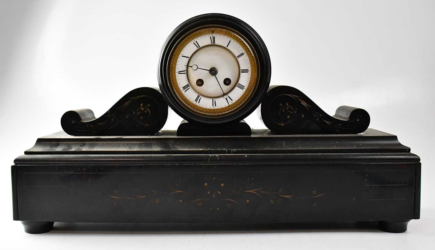 A Victorian slate drum head eight-day mantel clock, the enamelled dial set with Roman numerals,