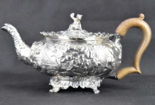 A George III hallmarked silver teapot with all-over Oriental and floral pattern extending to spout