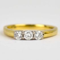 An 18ct gold ring set with three claw set brilliant cut diamonds, each approx. 0.15ct, size P,