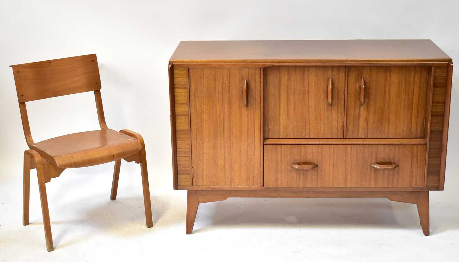 E. GOMME FOR G-PLAN; a mid-century teak sideboard, with pair of doors above long drawer with
