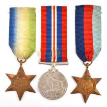 Three WWII medals comprising a Silver War Medal and ribbon, the Atlantic Star and ribbon, and the
