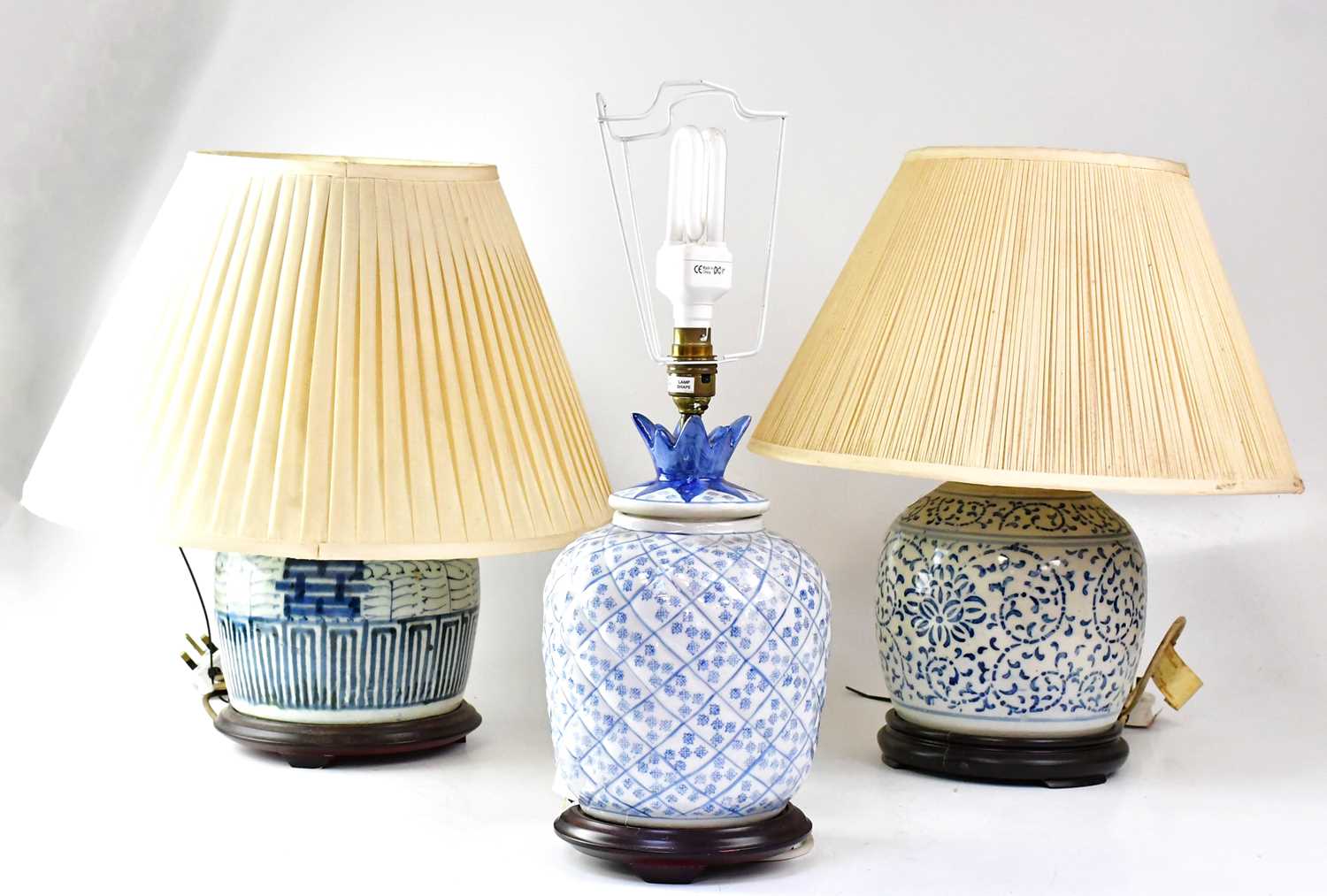 Three 20th century Chinese porcelain blue and white table lamps in the form of ginger jars, on