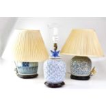 Three 20th century Chinese porcelain blue and white table lamps in the form of ginger jars, on