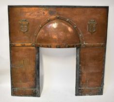 A hooded copper fire surround with armorial crests, 102 x 107cm. Condition Report: Overall rather