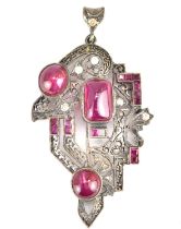 An Edwardian pendant set with an arrangement of cabochon bezel set rubies and rose cut small