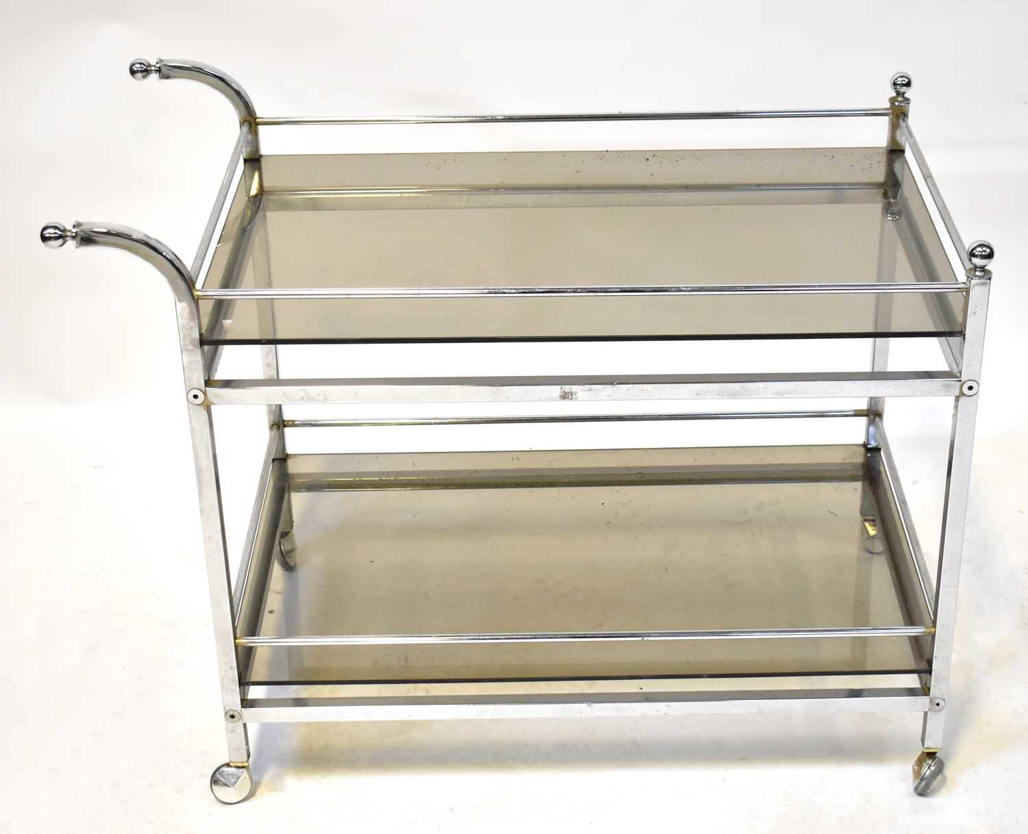 A smoked glass and chrome two-tier drinks trolley, 87 x 66 x 47cm.