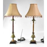 A pair of metal table lamps with columns in the form of palm trees, to lion paw feet, together