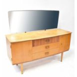 An Austin Suite mid-20th century teak dressing table with rectangular mirror above a base of three