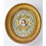 A 19th century Berlin ceramic plaque painted with a head and shoulders portrait of the Madonna, oval