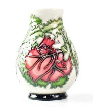 MOORCROFT; a small vase decorated with pink flowers on a cream ground, copyrighted for 1996, with