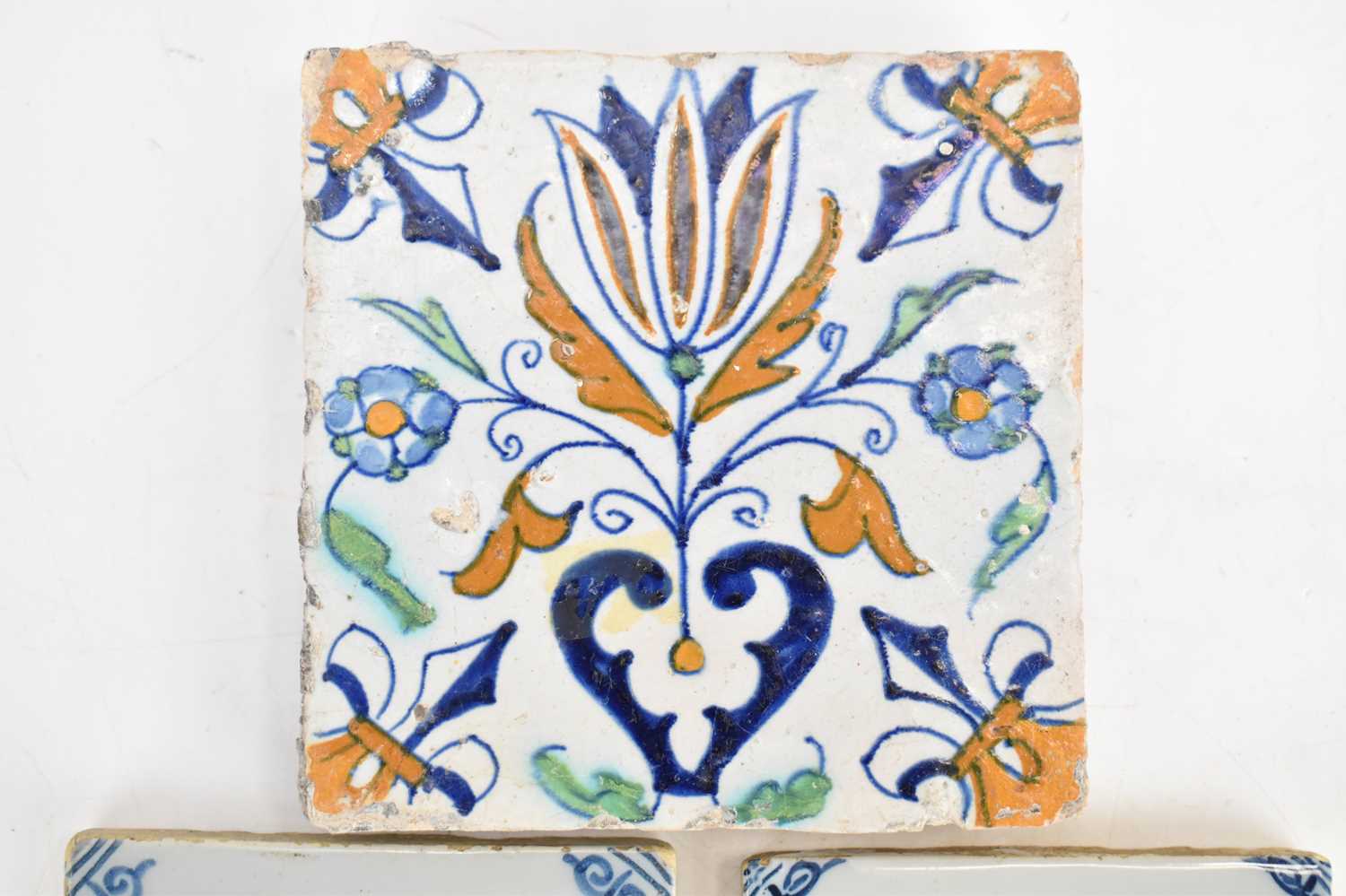 Three 18th century tin glazed tiles comprising a large polychrome decorated tulip and floral pattern - Image 2 of 7