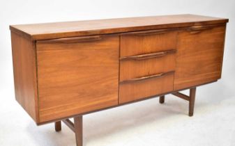 A mid-20th century teak sideboard with three short drawers and a pair of cupboard doors, on square