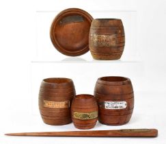 Four teak match barrels made from the wood of various vessels, with metal plaques, comprising 'HMS