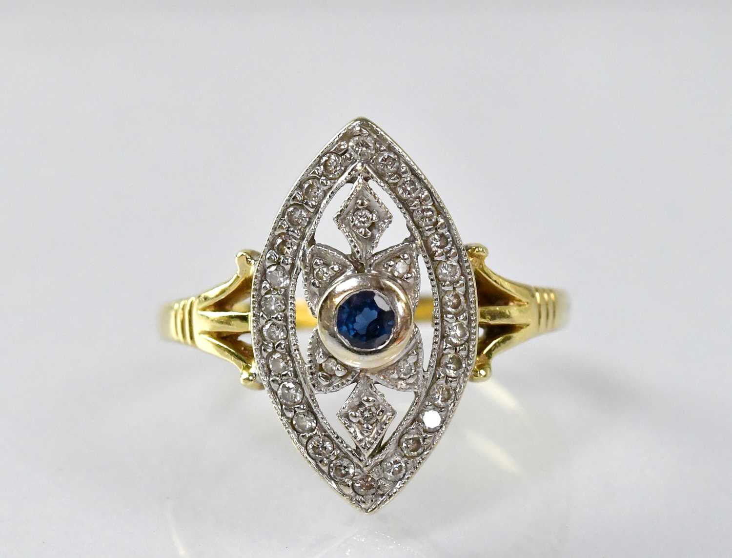 An 18ct yellow gold sapphire and diamond marquise-shaped cluster ring, size O, approx. 4.8g.