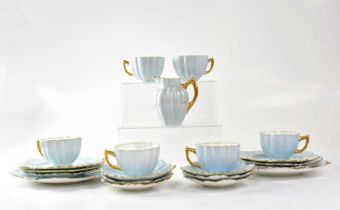 AYNSLEY; a pale blue and gilt-heightened petal-shaped tea set comprising six cups and saucers, a