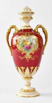 ROYAL WORCESTER; a twin-handled waisted vase with red ground and painted cartouche of roses, gilt