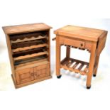 A pine kitchen wall-hanging unit with four racks for bottles above a pair of cupboard doors, 92 x 68