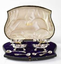 MARTIN, HALL & CO; a cased set of four Victorian hallmarked silver salts, with a set of three