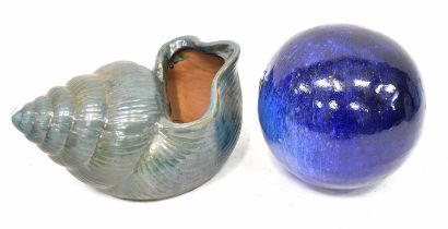 A large ceramic model of a shell in green glaze, 23 x 42cm, and a ceramic ball in dark blue