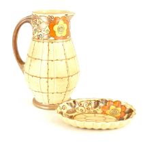 CHARLOTTE RHEAD FOR BURSLEY WARE; a large tube-lined floral jug, height 23cm, and an oval dish
