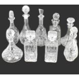 Nine various pressed glass and lead crystal moulded decanters with stoppers, to include a pair of