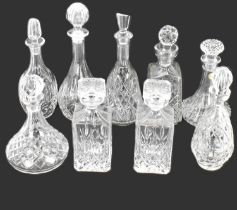 Nine various pressed glass and lead crystal moulded decanters with stoppers, to include a pair of